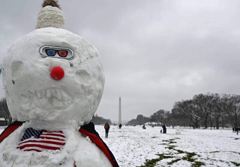 A masked snowman sits on the National Mall in Washington, DC. AFP