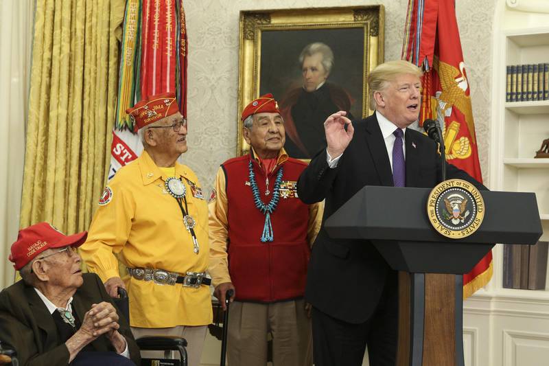 U.S. President Donald Trump, right, speaks during an event honoring World War II veteran Native American "Code Talkers" inside the Oval Officer of the White House in Washington, D.C., U.S., on Monday, Nov. 27, 2017. Trump punctuated a meeting with Native American veterans on Monday by calling Massachusetts Senator Elizabeth Warren "Pocahontas" -- a racially-tinged nickname he's deployed for years to belittle one of his chief Democratic antagonists. Photographer: Oliver Contreras/Pool via Bloomberg