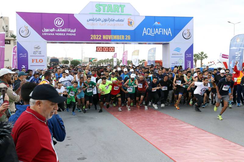 Participants take off from the starting line during the Tripoli marathon, in the Libyan capital on November 26, 2022.  (Photo by Mahmud Turkia  /  AFP)