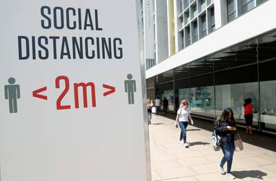 FILE PHOTO: A social distancing sign is seen in Oxford Street, as the outbreak of the coronavirus disease (COVID-19) continues, in London, Britain June 22, 2020. REUTERS/John Sibley/File Photo
