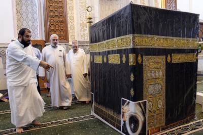 Iraqi pilgrims walk around the model of Kaaba during a lecture on performing the Hajj rituals in Tikrit, Iraq. AP Photo