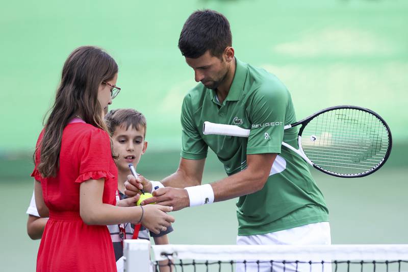 Serbia's Novak Djokovic signs autographs. AP Photo