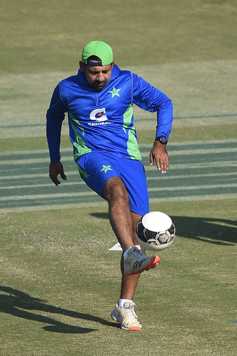 Pakistan's Sarfaraz Ahmed plays with ball during a training session in Karachi. AFP