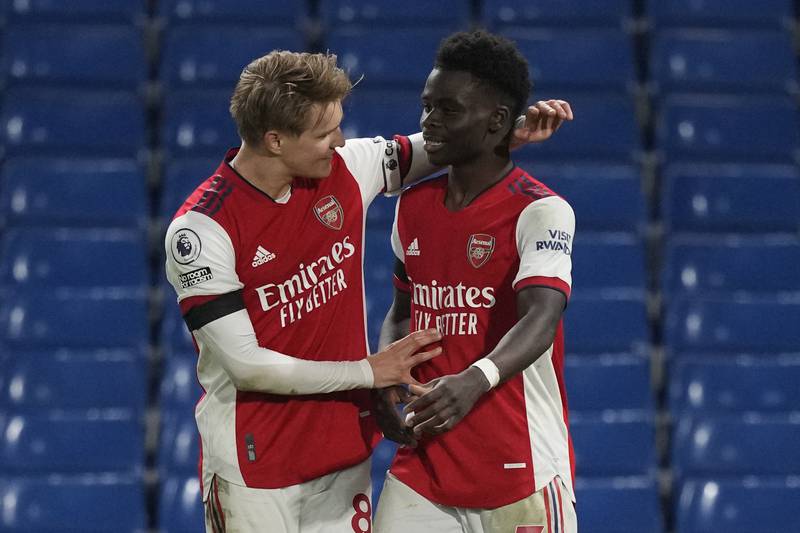 Bukayo Saka, right, celebrates after scoring a late penalty in Arsenal's 4-2 Premier League win over Chelsea at Stamford Bridge on Wednesday, April 20, 2022. AP