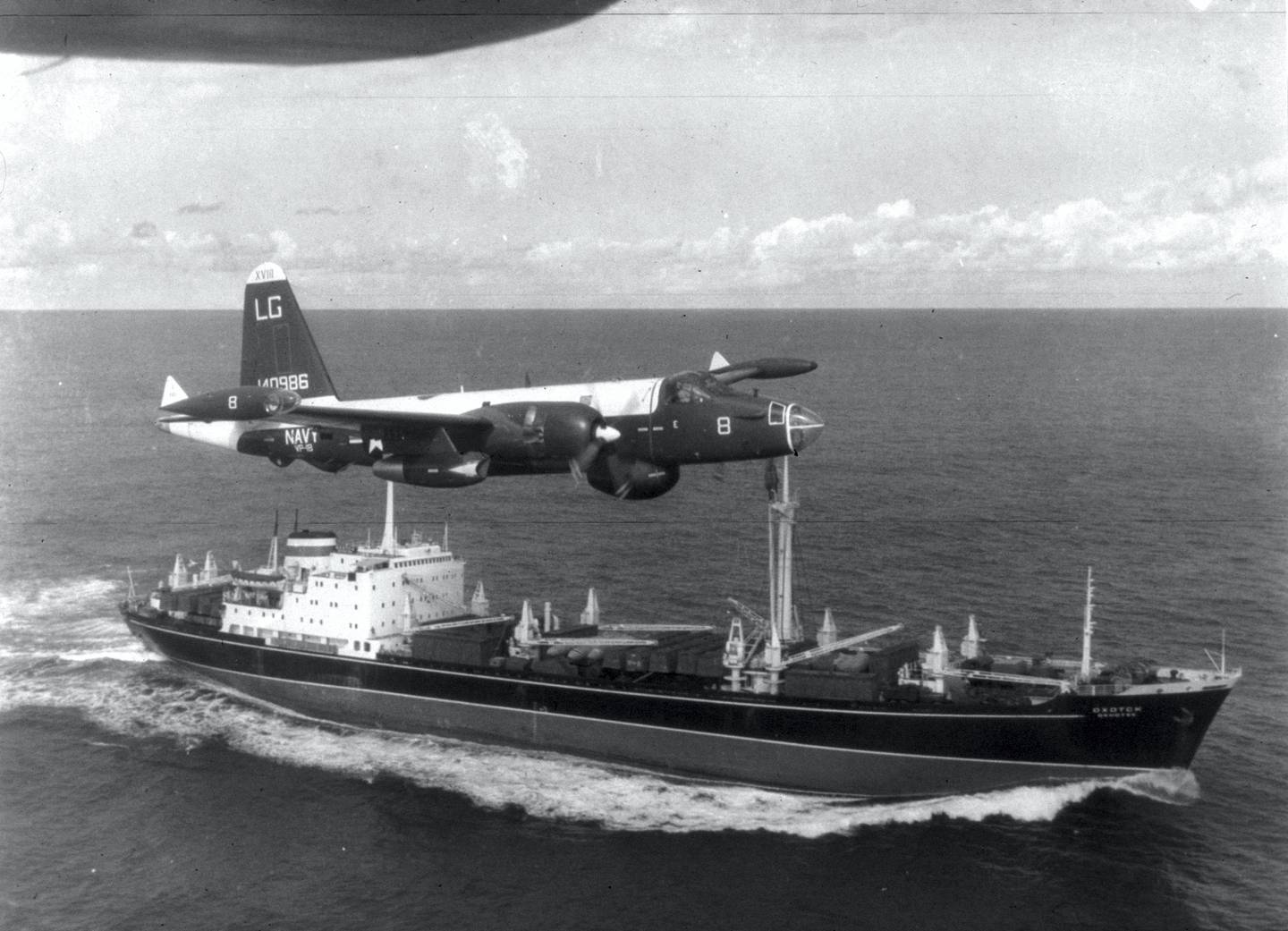 AT SEA:  (EDITORIAL USE ONLY)  (FILE PHOTO)  A P2V Neptune U.S. patrol plane flies over a Soviet freighter during the Cuban missile crisis in this 1962 photograph. Former Russian and U.S. officials attending a conference commemorating the 40th anniversary of the missile crisis October 2002 in Cuba said that the world was closer to a nuclear conflict during the 1962 standoff between Cuba and the U.S., than governments were aware of.  (Photo by Getty Images)