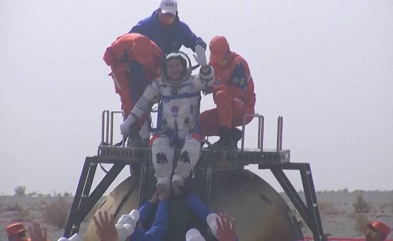 Chinese astronaut Zhai Zhigang waves atop the capsule of the Shenzhou-13 spacecraft. AFP
