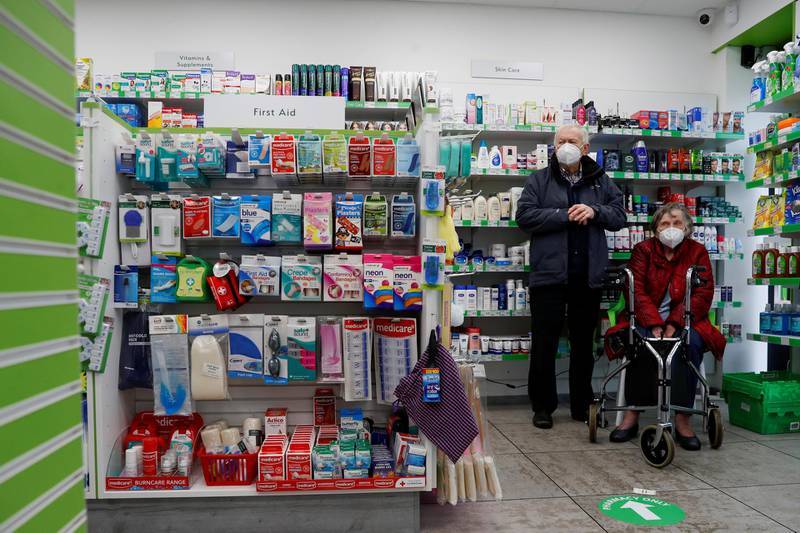 People wait at Cullimore Chemist to receive the Oxford/AstraZeneca vaccine in Edgware, London. Reuters