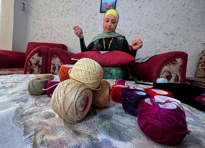 Bothaina Alayan an embroiderer at Gioia footwear, works from home in Amman, Jordan. All photos: Reuters