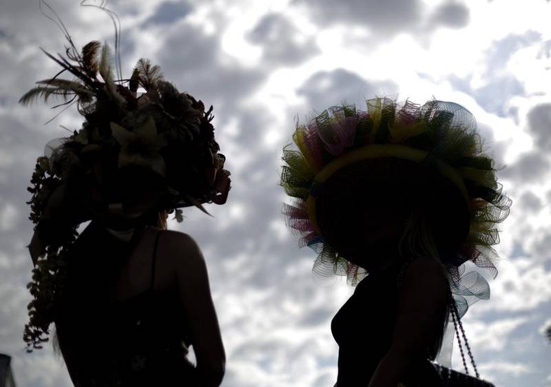 Ashley Cebak and Tami Purcell wear hats before the 140th running of the Kentucky Derby horse race at Churchill Downs. David Goldman / AP Photo