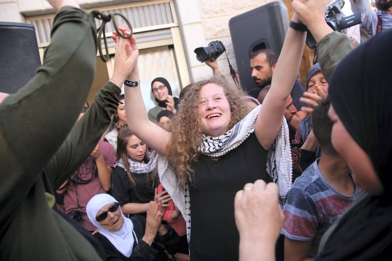 Ahed Tamimi celebrates with friends and family as she arrives to her home in the West Bank village of Nebi Salah. Photo by Heidi Levine for the National 
