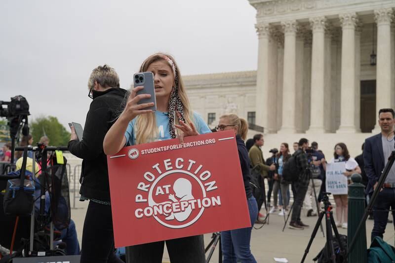 Savana Deretich a member of the group Students for Life of America records a video on her phone. Willy Lowry / The National