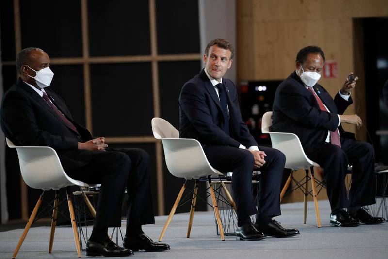 French President Emmanuel Macron, center, Sudan's Prime Minister Prime Minister of Sudan Abdallah Hamdok, right, and Gen. Abdel-Fattah Burhan, head of Sudan's ruling sovereign council attend a session of the summit to support Sudan. AP Photo