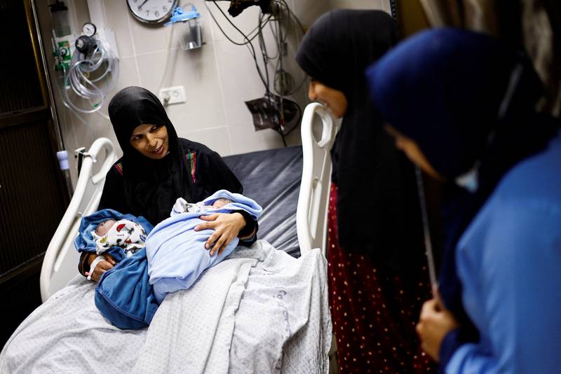 A Palestinian holds her newborn twins at Nasser Hospital, in Khan Younis, in the southern Gaza Strip. Reuters