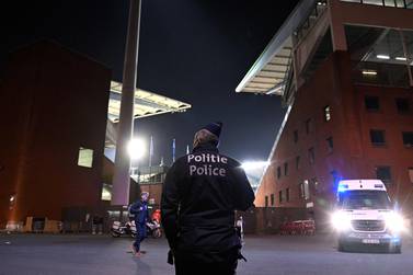A police officer stands guard outside the King Baudouin Stadium following the Euro 2024 qualifying football match between Belgium and Sweden in Brussels on October 16, 2023, after two Swedes were shot dead in an attack in Brussels.  Belgium's Euro 2024 qualifier against Sweden was abandoned at half-time and fans were kept in the stadium for security reasons after two Swedes were shot dead in an attack in Brussels on October 16, 2023.  (Photo by JOHN THYS  /  AFP)