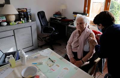 A 101 year old patient receives a dose of the Pfizer/BioNTech vaccine from a nurse at her house in Gonnelieu, France. Reuters