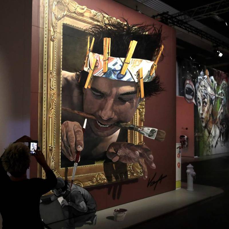 A woman takes pictures of a 3D artwork by Mexican artist Juandres Vera in Munich, Germany. Matthias Schrader / AP Photo