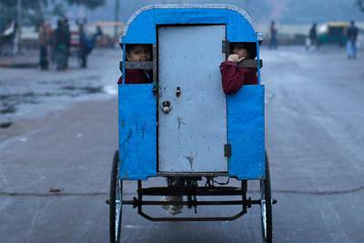 Schoolchildren travel to their school in a cycle rickshaw on a cold morning in the old quarters of Delhi. Ahmad Masood / Reuters