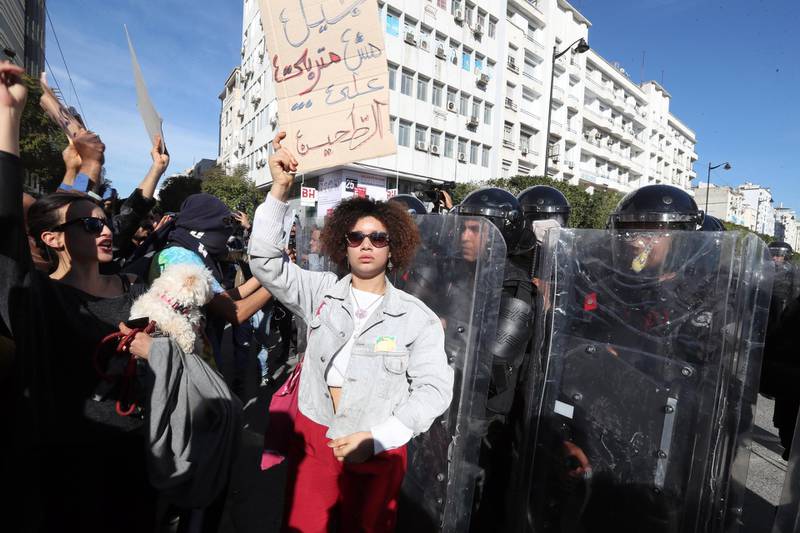 A protester holds a placard reading in Arabic "this generation was not raised on awkwardness" during a demonstration in Tunis. EPA
