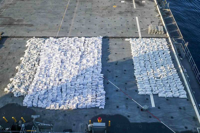 Bags containing fuses and propellants for rockets are arranged on the flight deck of the USS Lewis B Puller, whose crew discovered the weapons on a smuggling vessel. 