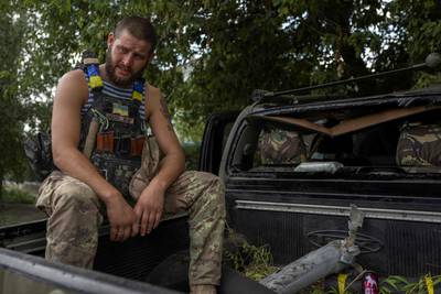 A Ukrainian soldier after a rocket fragment hit his car, in Bakhmut. AFP