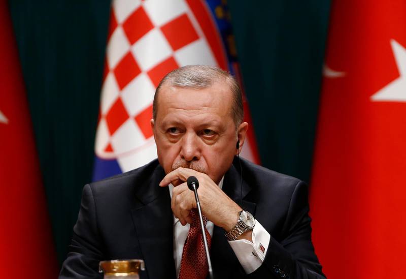 Turkey's President Recep Tayyip Erdogan talks during a joint news conference with Croatia's President Kolinda Grabar-Kitarovic, following their meeting at the Presidential Palace in Ankara, Turkey, Wednesday, Jan. 16, 2019. Erdogan said that an explosion that killed U.S. service members, during a routine patrol in the northern Syrian town of Manbij, may have been an act aimed to deter the United States from withdrawing troops. (AP Photo/Burhan Ozbilici)