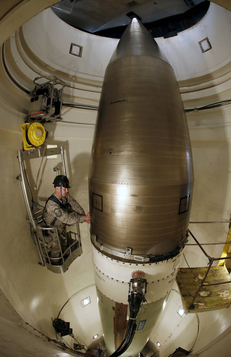 Master Sgt Tad Wagner looks over an inert Minuteman 3 missile in a US training launch tube at Minot Air Force Base, North Dakota. AP