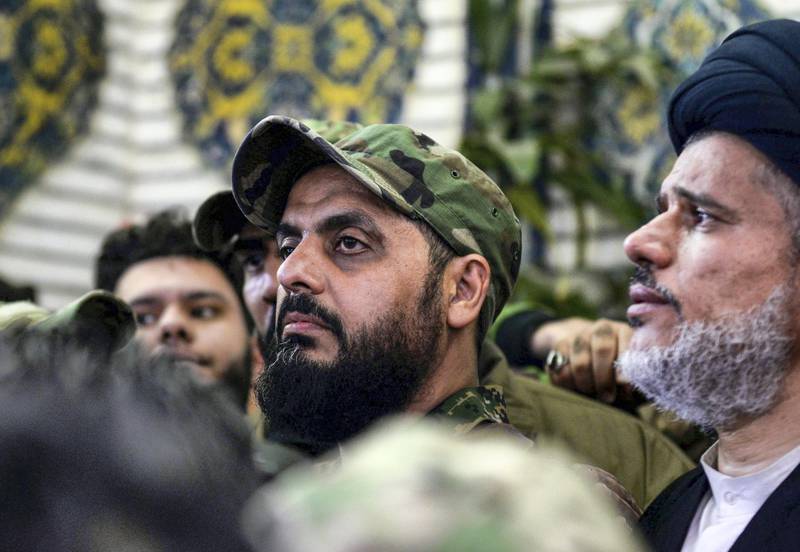 Qais al-Khazali (C) commander of the Asaib Ahl al-Haq pro-Iran faction attends the funeral procession of slain Iraqi paramilitary chief Abu Mahdi al-Muhandis, Iranian military commander Qasem Soleimani and eight others at the Imam Ali Shrine in the shrine city of Najaf in central Iraq on January 4, 2020. - Thousands of Iraqis chanted "Death to America" today as they mourned the deaths of  al-Muhandis and Soleimani, who were killed in a US drone attack that sparked fears of a regional proxy war between Washington and Tehran. (Photo by Haidar HAMDANI / AFP)