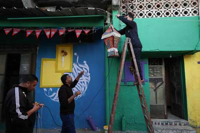 A Ramadan lantern is hung on a wall painted in vivid colours in the Zeitun district of Gaza city. AFP