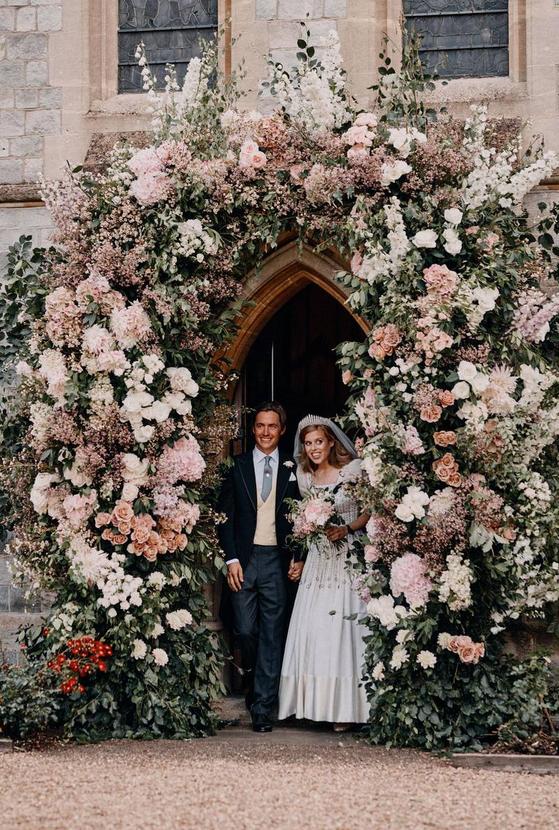 In this photograph released by the Royal Communications of Princess Beatrice and Edoardo Mapelli Mozzi, Britain's Princess Beatrice and Edoardo Mapelli Mozzi stand in the doorway of The Royal Chapel of All Saints at Royal Lodge, Windsor, England, after their wedding on Saturday July 18, 2020. Princess Beatrice wore a vintage dress loaned to her by Queen Elizabeth II at her wedding, Buckingham Palace said Saturday as it released official photographs from the small family event. (Benjamin Wheeler/Royal Communications of Princess Beatrice and Edoardo Mapelli Mozzi via AP)