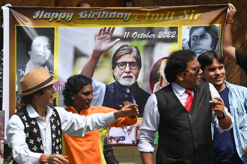 Fans carry a special sign of Bachchan as he marks his milestone year.