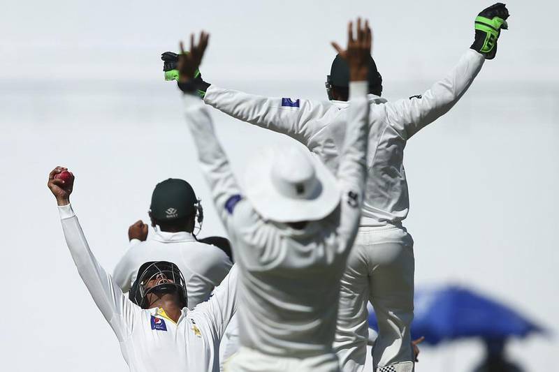 Azhar Ali of Pakistan celebrates after taking the catch off a Zulfiqar Babar delivery to dismiss Nathan Lyon and claim victory on Day 5 of the second Test in Abu Dhabi on Monday, Ryan Pierse / Getty Images / November 3, 2014