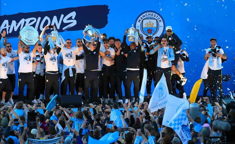 Manchester City players and staff on stage during the trophy parade in Manchester, England, after winning the English FA Cup. Victory for Pep Guardiola’s side came a week after the English Premier League trophy was retained to join the League Cup and Community Shield already in City’s possession.  AP