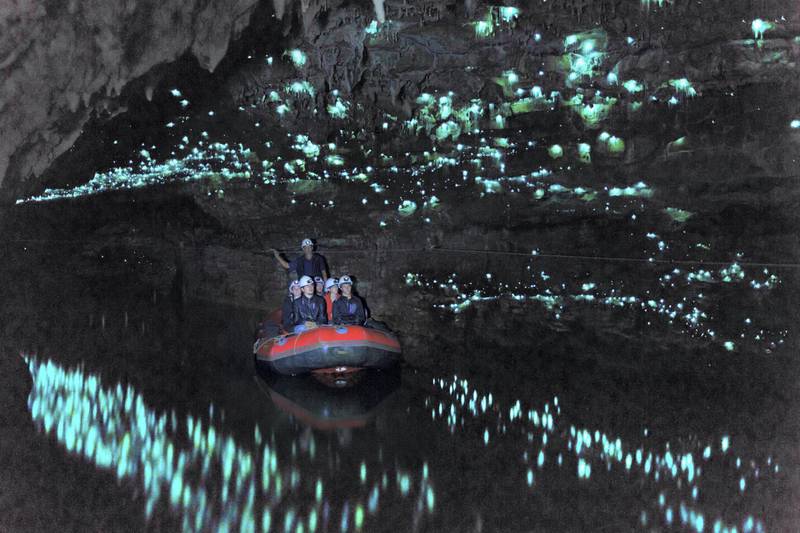 Tourists looking at famous glowworm cave, Waitomo caves, New Zealand