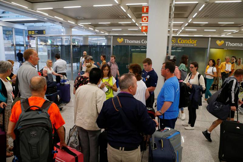 Passengers are seen at Thomas Cook check-in points at Mallorca Airport as an announcement is expected on the tour operator's attempts to secure 200 million pounds in extra funding to reach agreement over its recapitalisation and secure its future, Palma de Mallorca, Spain. REUTERS