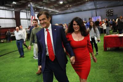 Pennsylvania US  Senate candidate Dr Mehmet Oz and his wife Lisa leave a Republican leadership forum on May 11, in Pennsylvania. Mr Oz has been endorsed by former US President Donald Trump. Getty Images / AFP