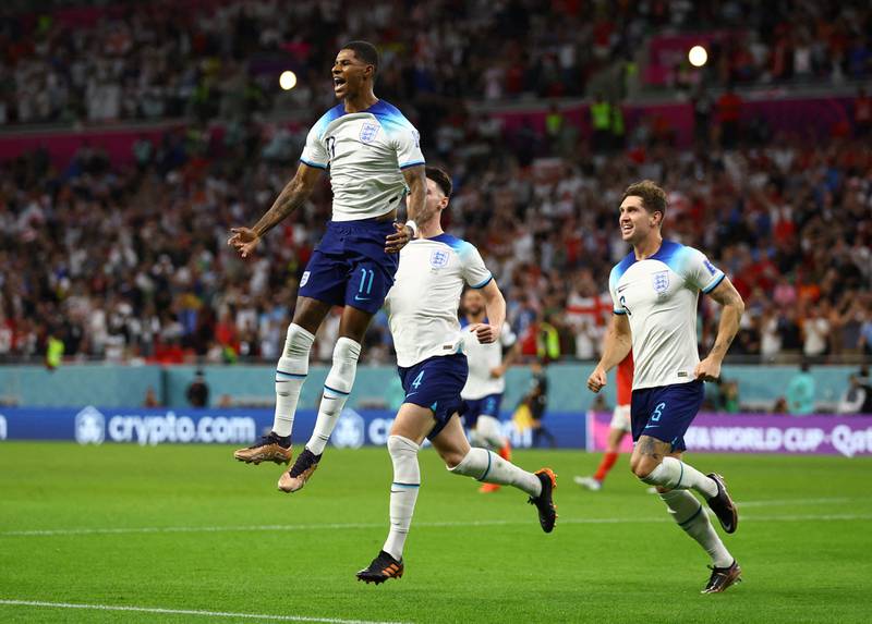 England's Marcus Rashford celebrates scoring their first goal with Declan Rice and John Stones. Reuters