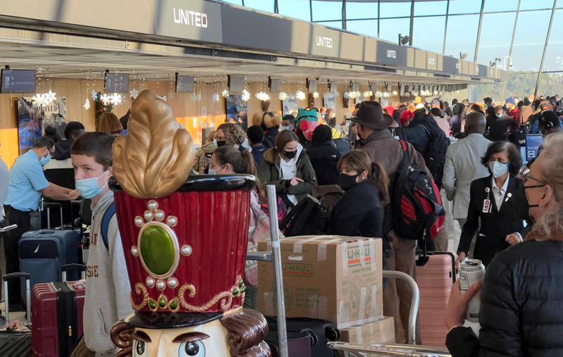 Holiday travellers transit through Dulles International Airport in Virginia. United Airlines chief executive Scott Kirby has said the coming two weeks are expected to be its busiest since the pandemic began, despite Omicron. AFP