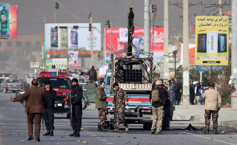 Security personnel inspect a damaged vehicle which was carrying and shooting rockets, in the aftermath of a rocket attack in Kabul, Afghanistan. According to media reports at least three people were killed and 11 others were injured as multiple rockets landed on the Afghann capital.  EPA