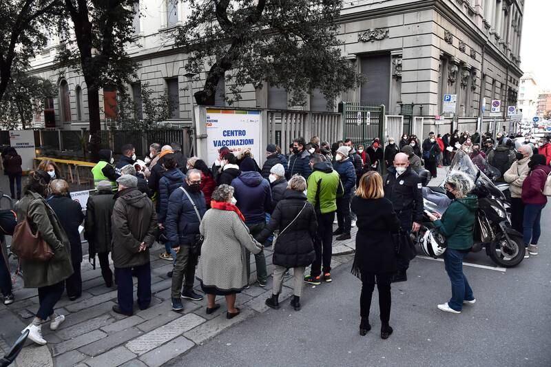 People stand in line for a Covid-19 shot at the Gioventu Theatre in Genoa, Italy, on January 10. EPA