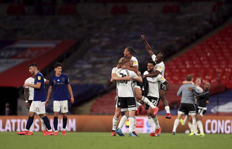 Fulham's players celebrate at the final whistle. PA