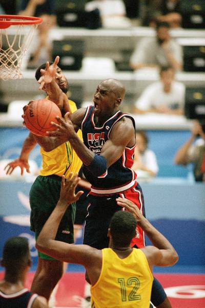 USA's Michael Jordan takes the ball to the hoop past the outstretched arms of Brazil's Josuel Aristides Santos for two points during first half action of their game at the 1992 Olympic Games in Barcelona. AP