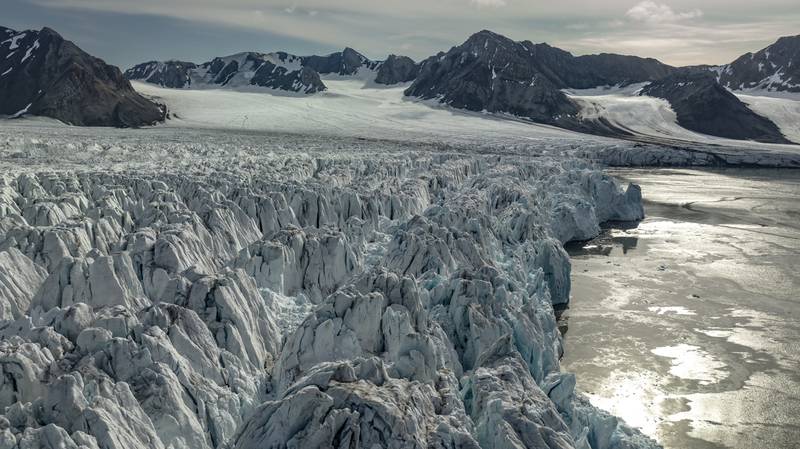 An aerial view of the glaciers and icebergs in Nordvest-Spitsbergen National Park in July. Scientists observed the impacts of climate change by observing the glaciers, melting and breaking off into the sea. Getty Images