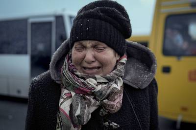 A woman cries after arriving at the triage point in Kyiv. AP