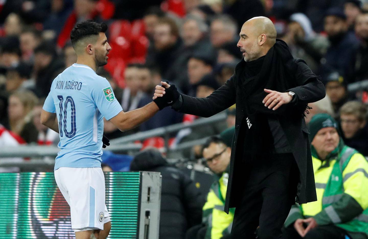 Soccer Football - Carabao Cup Final - Arsenal vs Manchester City - Wembley Stadium, London, Britain - February 25, 2018   Manchester City manager Pep Guardiola shakes hands with Sergio Aguero as he is substituted     Action Images via Reuters/Carl Recine     EDITORIAL USE ONLY. No use with unauthorized audio, video, data, fixture lists, club/league logos or "live" services. Online in-match use limited to 75 images, no video emulation. No use in betting, games or single club/league/player publications. Please contact your account representative for further details.