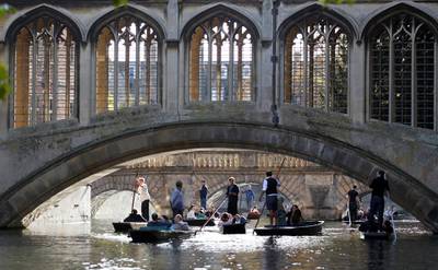 FILE PHOTO: People are seen punting on the River Cam near the Bridge of Sighs at St John's College, University of Cambridge, Britain, October 28, 2011. REUTERS/Suzanne Plunkett/File Photo