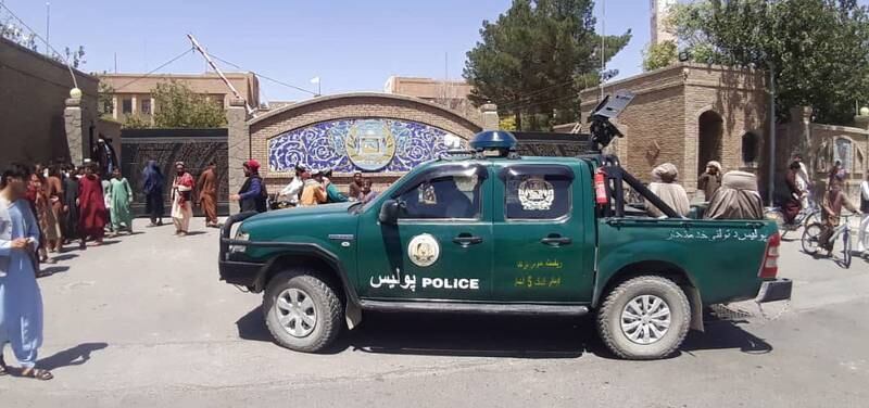 Taliban forces drive a police vehicle in Herat. EPA