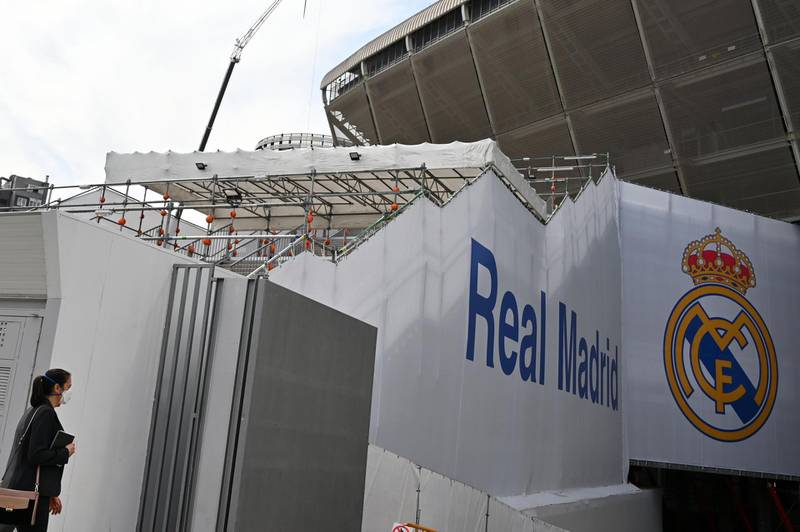 A woman wearing a protective face mask arrives at the Santiago Bernabeu stadium in Madrid as Real Madrid players went into quarantine due to the coronavirus outbreak, on March 12, 2020. Madrid were set to host Eibar in La Liga on Sunday. AFP