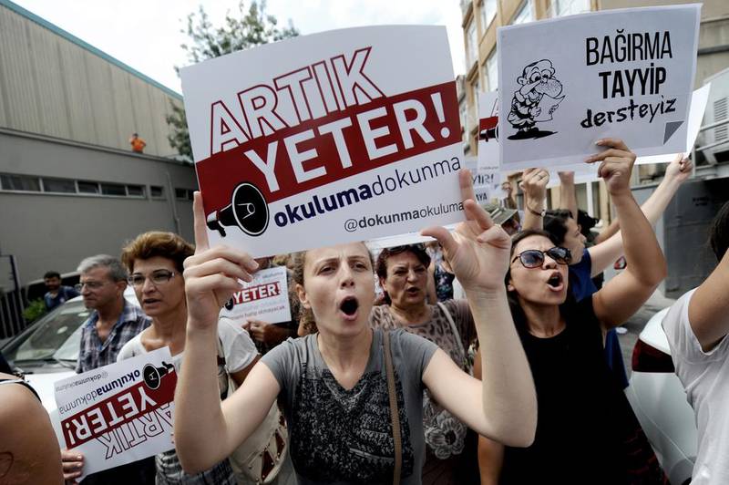 Protestors march with placards reading "Enough! Don't turn our schools to Imam Hatips", on August 25, 2014, at Kadikoy in Istanbul. AFP Photo / Ozan Kose 