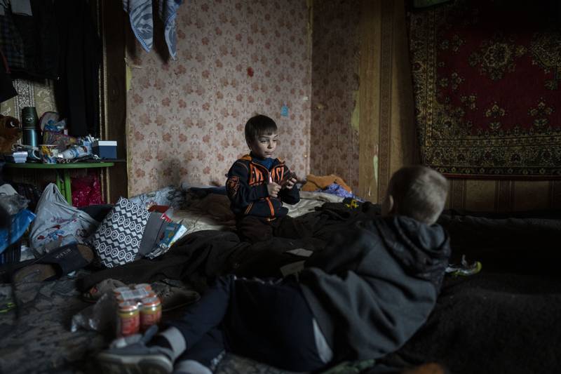 Vlad, the six-year old Ukrainian who lost his mother during their confinement in a Bucha basement amid the Russian invasion, plays with a friend inside his house. AP