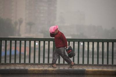 A man walks during a thunderstorm and heavy rains in Cairo. EPA